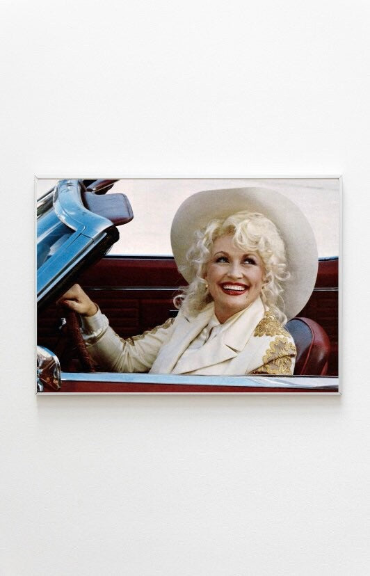 Dolly Parton wearing a cowboy hat driving photo Print